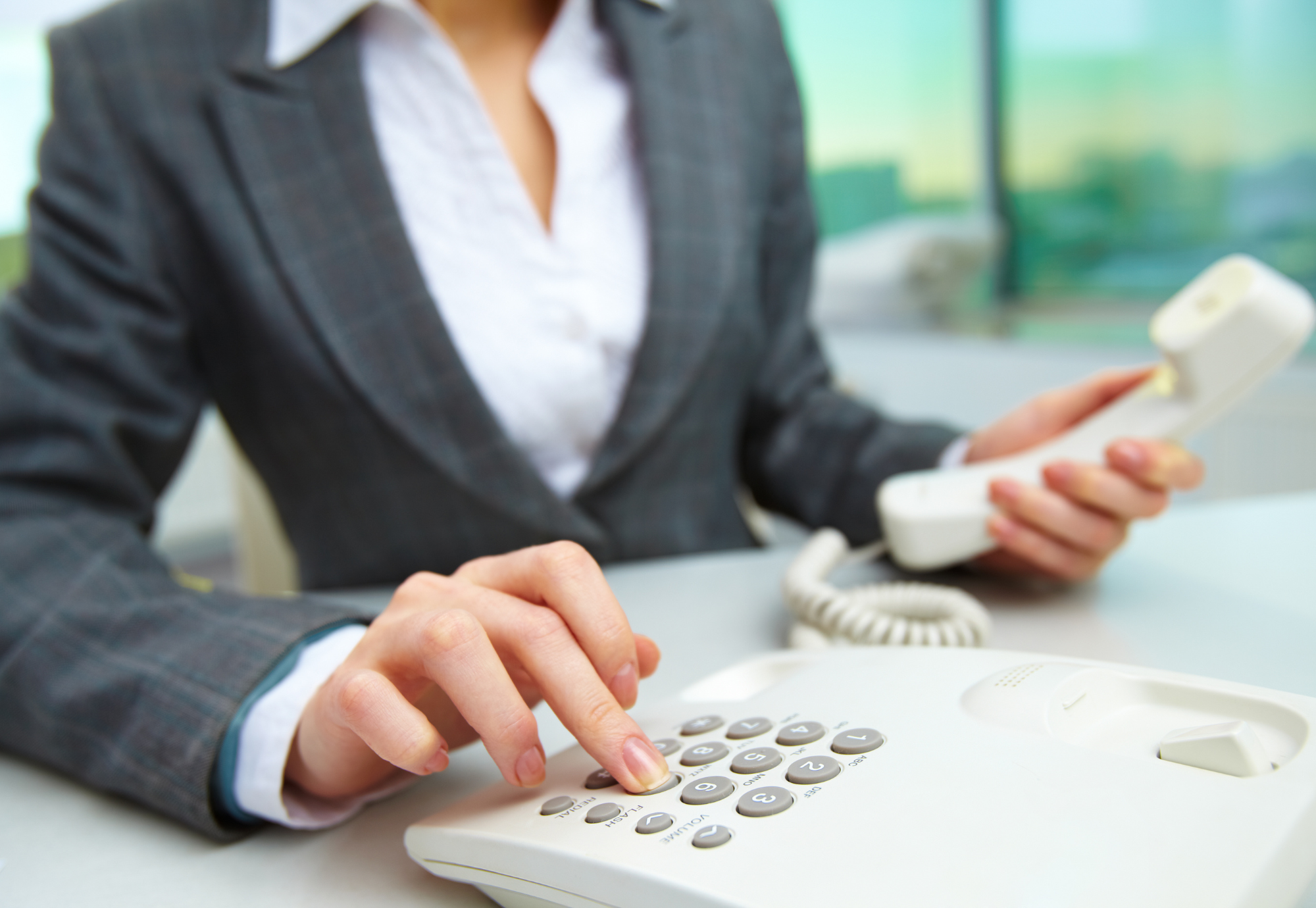 a hand pressing a call button or speaking on a headset